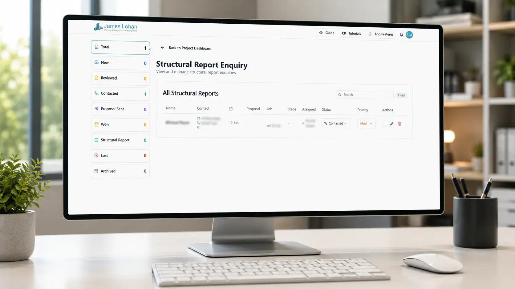 Structural report enquiry list displayed on a desktop monitor, with contact and job details redacted for privacy
